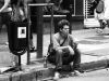sitting on sidewalk by Paulo Calvo